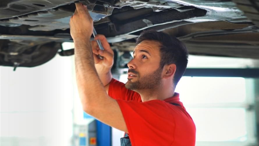 Picture of technician training on the undercarriage of a Toyota vehicle